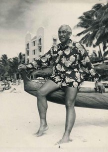 black and white image on man wearing printed aloha shirt